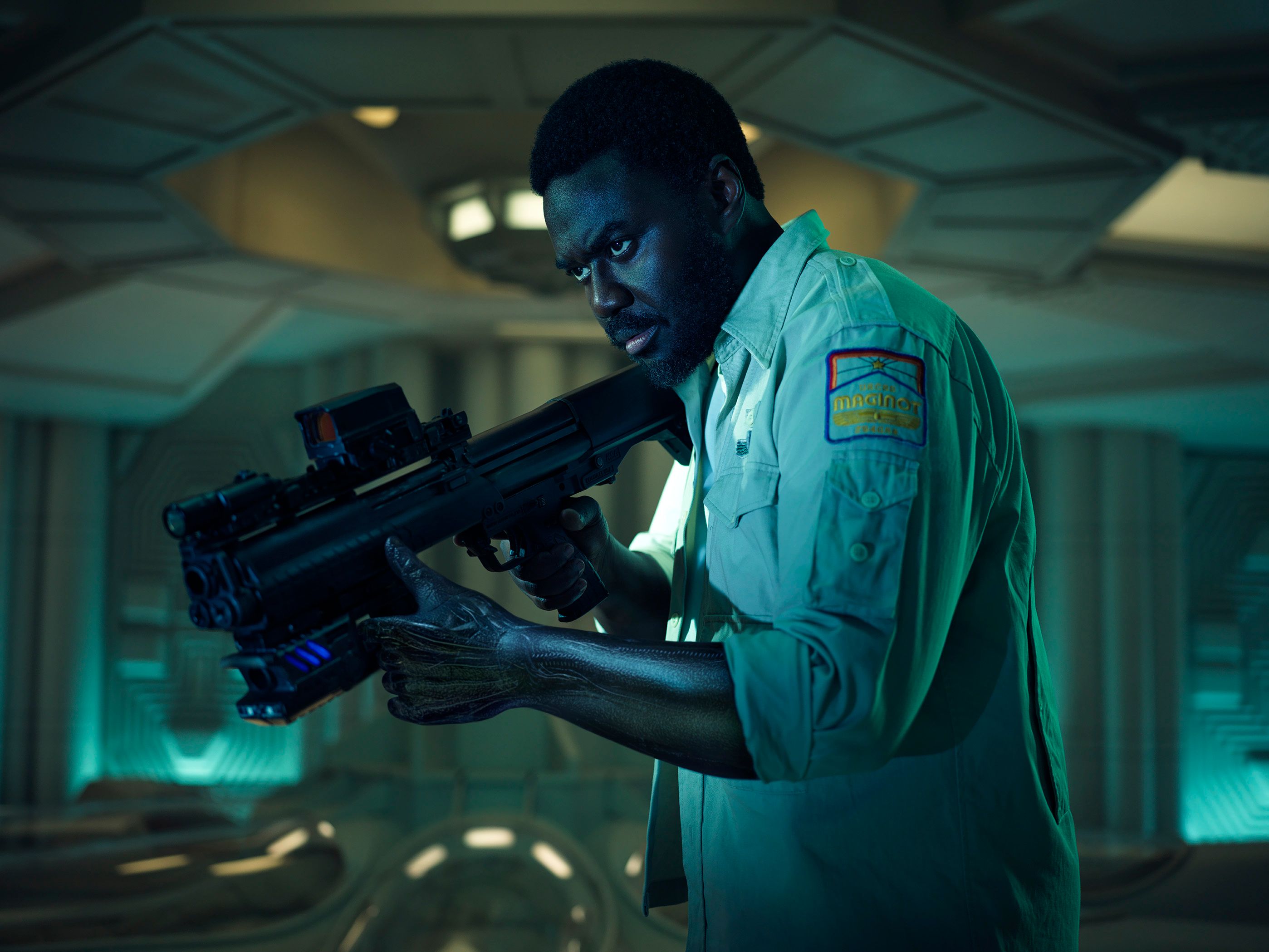 Babou Ceesay as Morrow in Alien Earth pointing a gun at an offscreen target