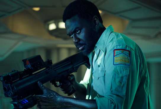Morrow from Alien: Earth holds a gun.